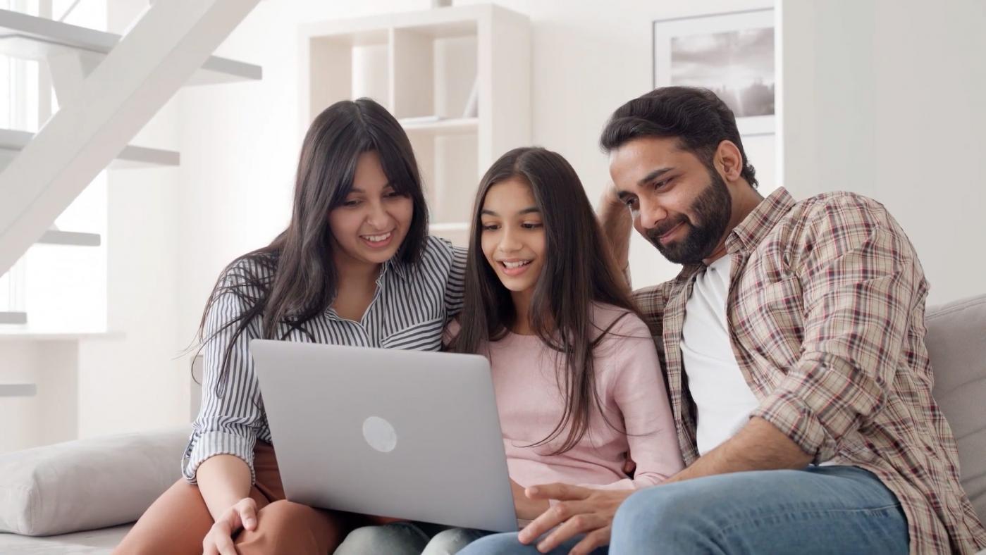 Family in new home looking at laptop